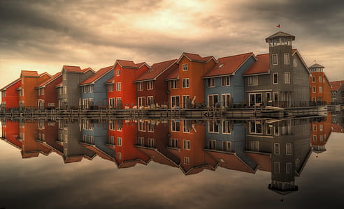 red and blue house near water photography thumbnail