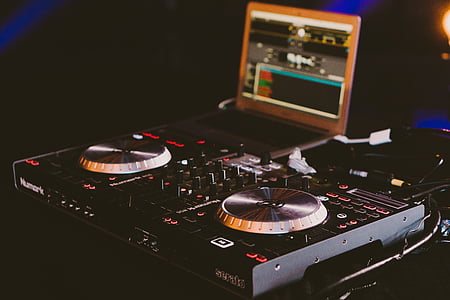 black Numark DJ controller near turned on laptop thumbnail