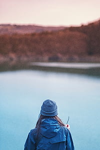 person standing near body of water during daytime thumbnail
