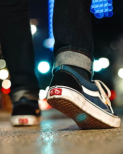 person wearing Vans sneakers while walking thumbnail