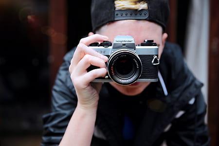 person holding black DSLR camera thumbnail