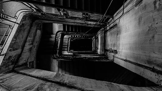 grayscale photography of pathway down the hall thumbnail