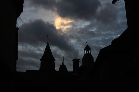 silhouette of church under cloudy sky thumbnail