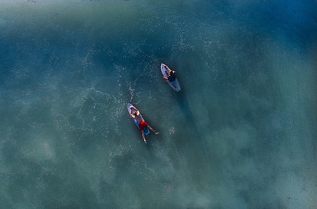 areal view photography of two person on surfboard thumbnail