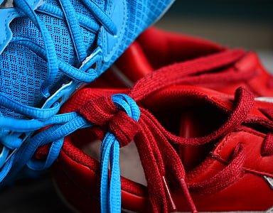 close-up photo of red and blue lace tied together thumbnail