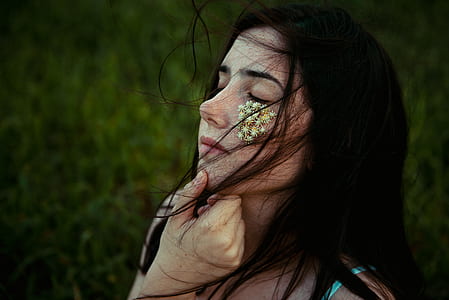 white petaled flower on woman's face at daytime thumbnail
