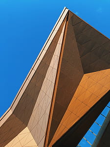 brown high-rise building under clear sky thumbnail