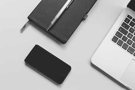 black iPhone 5 beside laptop thumbnail