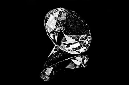 clear gemstone on reflective surface thumbnail