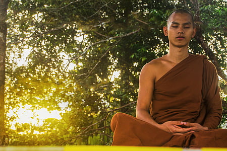photo of man in brown kasaya robe meditating thumbnail