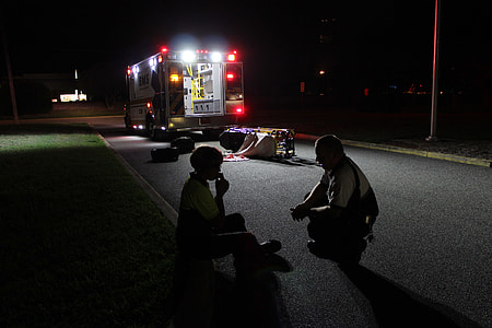two men sitting on road thumbnail