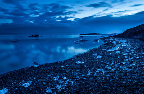 calm body of water on beach thumbnail