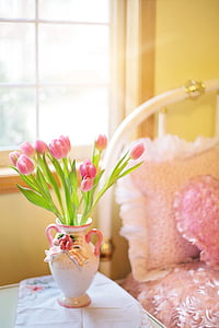pink tulip flowers with green leaf on white and pink ceramic vase thumbnail