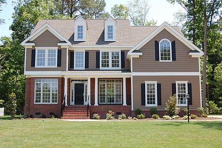 brown and white house near green trees thumbnail