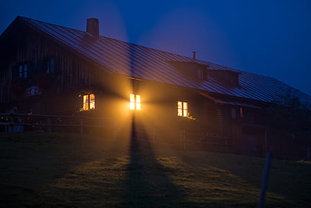 House With Orange Light during Night Time thumbnail