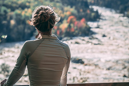 woman standing with body of water background thumbnail