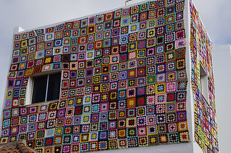 multicolored building under cloudy skies thumbnail