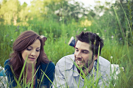 couple lying on grass field talking thumbnail