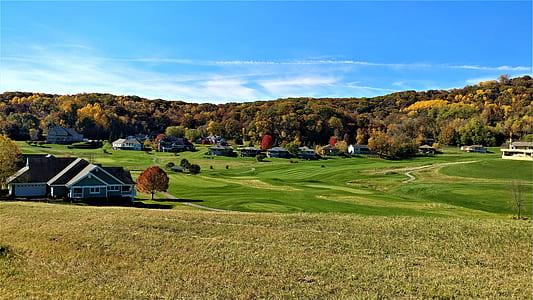 black and white house on green grass field thumbnail