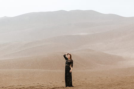 woman standing on brown sand thumbnail