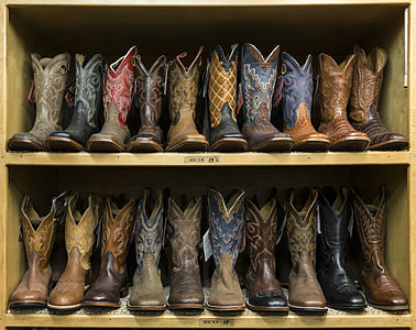 men's assorted cowboy boots on shoe rack thumbnail