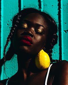 woman in white sleeveless top with lemon on her shoulder thumbnail