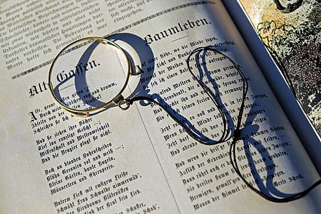 Black String on Top of an Open Book during Daytime thumbnail