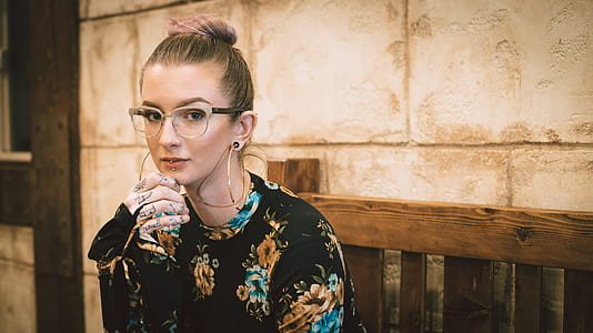 woman sitting on brown bench thumbnail