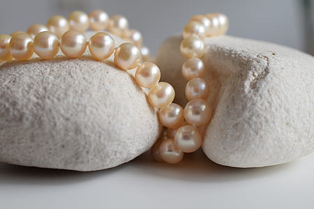 beaded pearl accessory on stones thumbnail