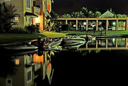 Speed Boats Docked Near House thumbnail
