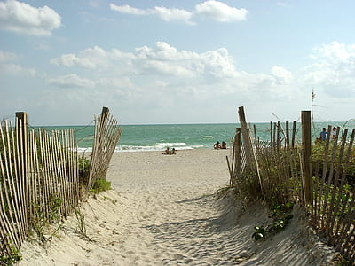 body of water across the sea shore during daytime thumbnail