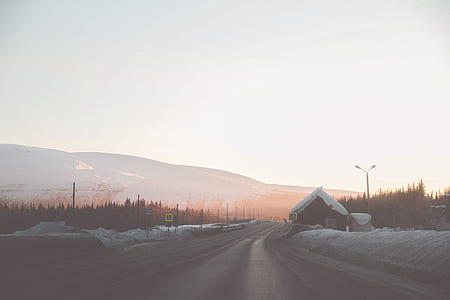 snow covered house near road thumbnail