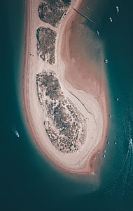 assorted boats beside island during daytime thumbnail