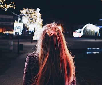 woman walking on street during night time thumbnail