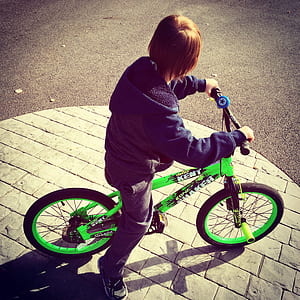 Boy Riding Bike at Daytime thumbnail