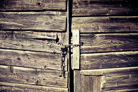 brown wooden door with chains thumbnail