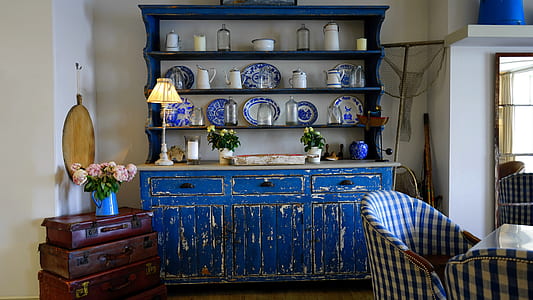 blue wooden sideboard with rack near chairs thumbnail