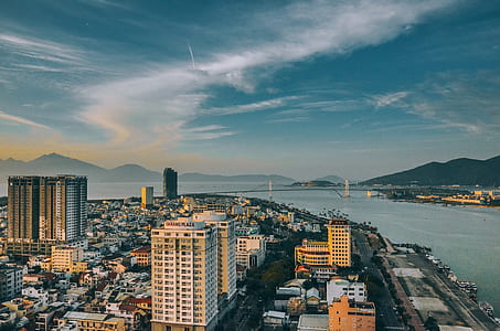 aerial view of skyscrapers near blue ocean water during daytime thumbnail