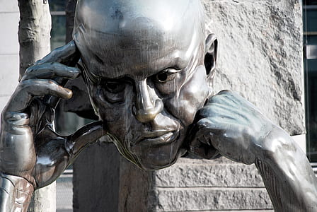 silver-colored bust with hand statue thumbnail