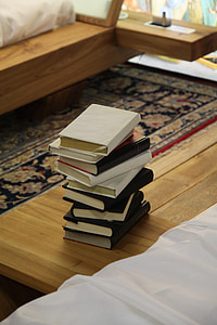 photo of piled books on table thumbnail