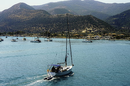 white and black power boat in calm waters thumbnail