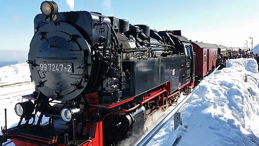 red and black train on snow field thumbnail