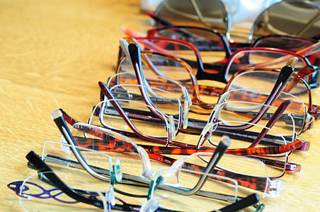 assorted-color eyeglasses on brown surface thumbnail