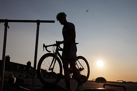 silhouette of man riding road bike thumbnail