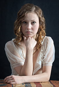 woman wearing white see through shirt resting her hand on her chin thumbnail