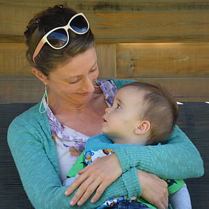 woman carrying baby thumbnail