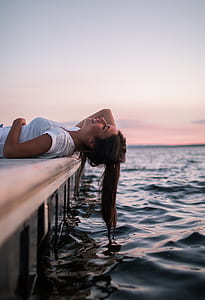 woman lying on wooden dock thumbnail