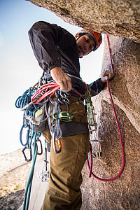 man doing mountain climbing at daylight photography thumbnail
