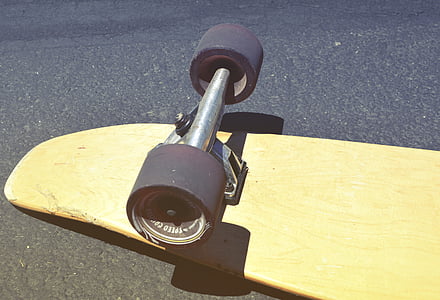 brown skateboard on black surface thumbnail