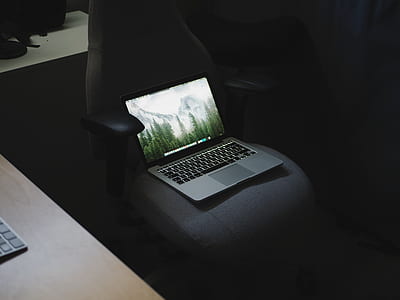 MacBook Pro on gray rotating armchair thumbnail